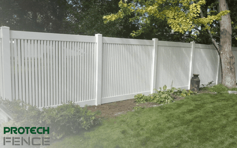 A picturesque view of a shadowbox vinyl fence installation elegantly lining a backyard. The shadowbox fence offers a semi-private design, allowing air flow while maintaining a level of privacy, seamlessly combining beauty and functionality. 